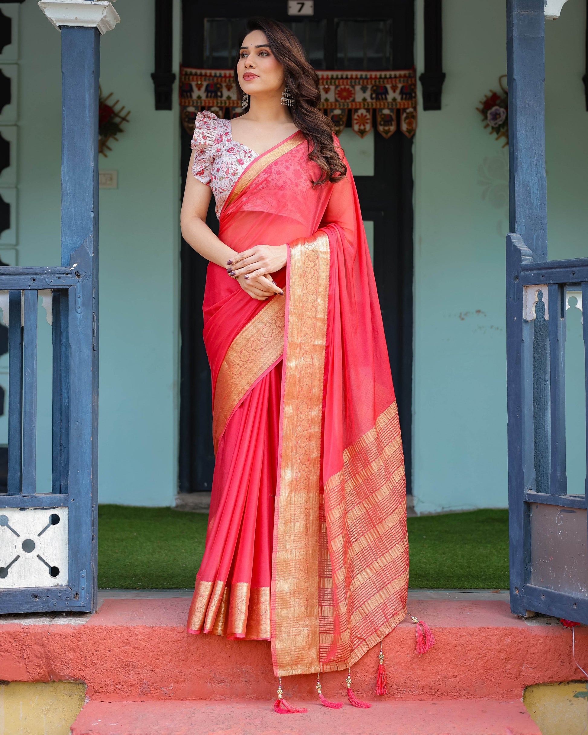 Vibrant Coral Pink Plain Chiffon Saree with Gold Zari Border, Floral Ruffled Blouse & Tassel Detailing - SEEANS