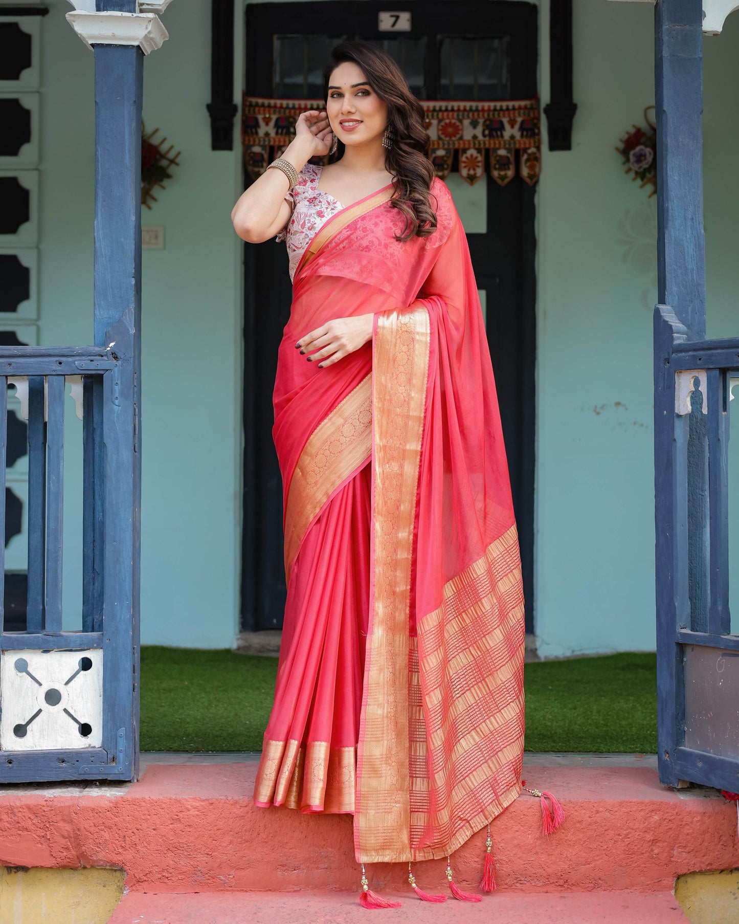 Vibrant Coral Pink Plain Chiffon Saree with Gold Zari Border, Floral Ruffled Blouse & Tassel Detailing - SEEANS