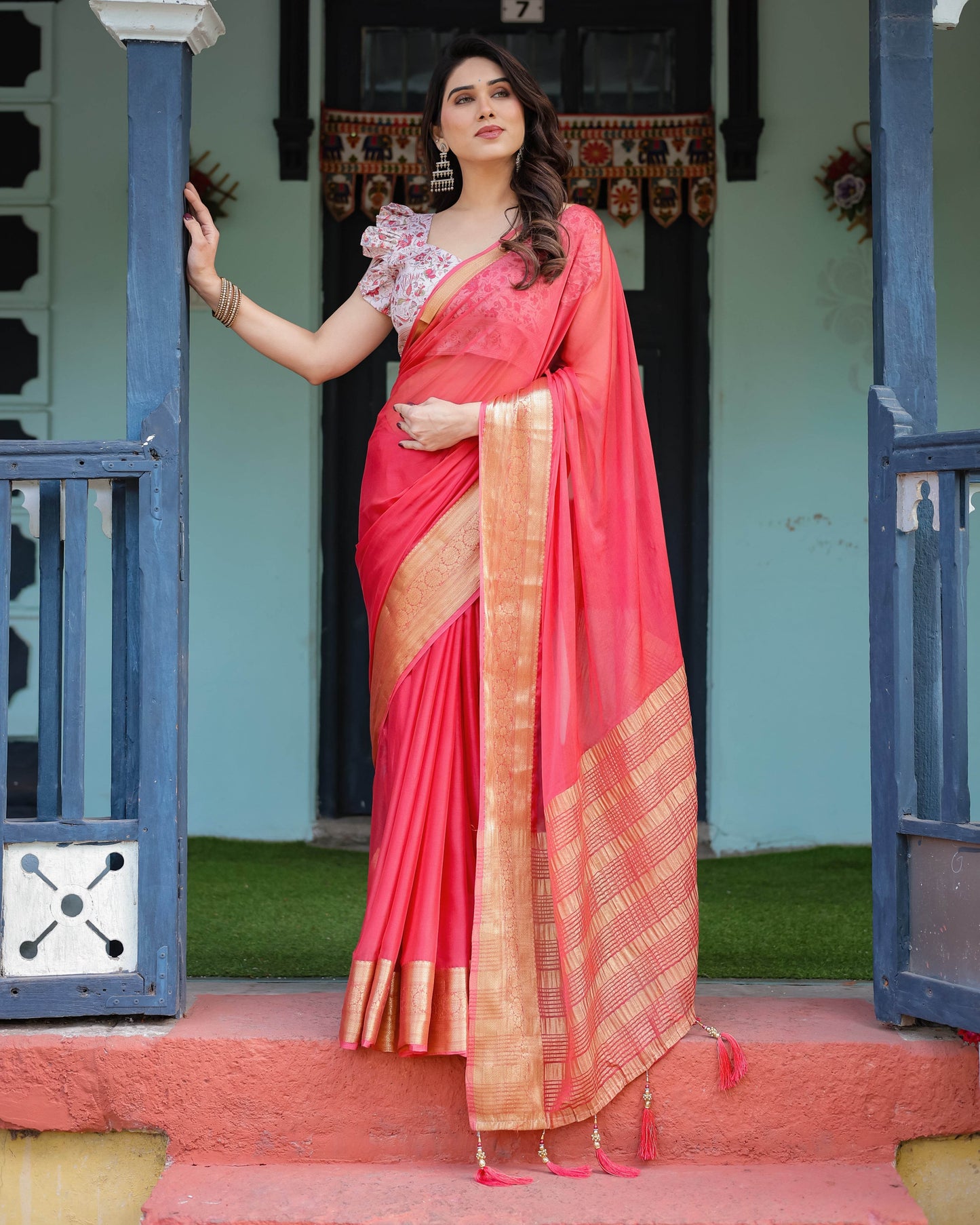 Vibrant Coral Pink Plain Chiffon Saree with Gold Zari Border, Floral Ruffled Blouse & Tassel Detailing - SEEANS