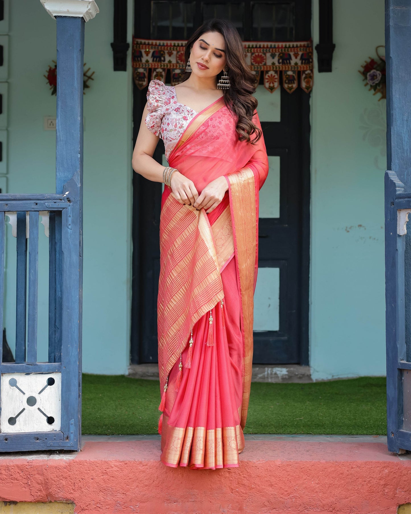 Vibrant Coral Pink Plain Chiffon Saree with Gold Zari Border, Floral Ruffled Blouse & Tassel Detailing - SEEANS