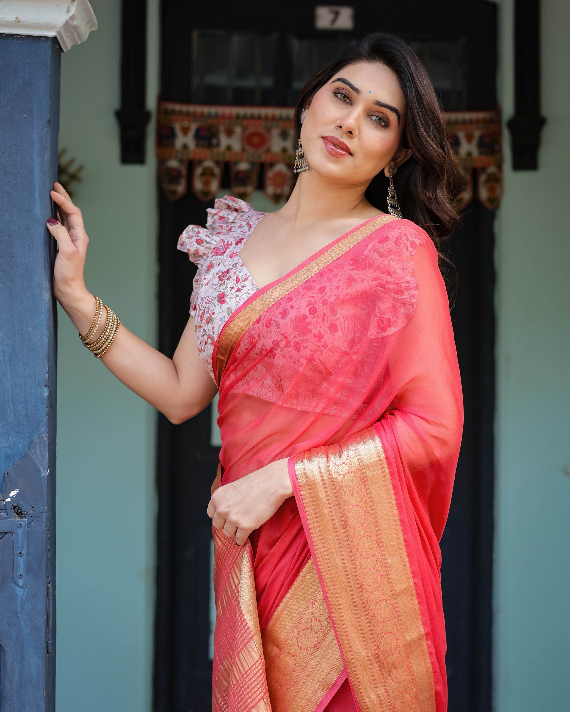 Vibrant Coral Pink Plain Chiffon Saree with Gold Zari Border, Floral Ruffled Blouse & Tassel Detailing - SEEANS