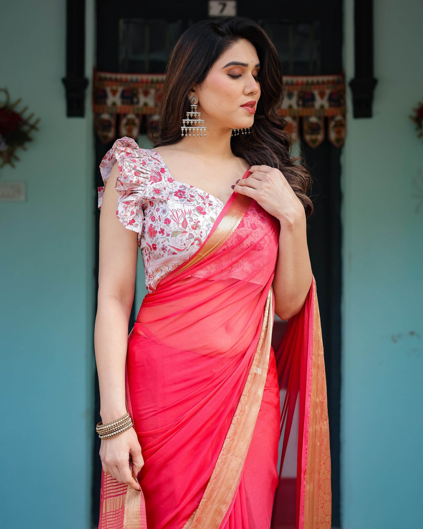 Vibrant Coral Pink Plain Chiffon Saree with Gold Zari Border, Floral Ruffled Blouse & Tassel Detailing - SEEANS