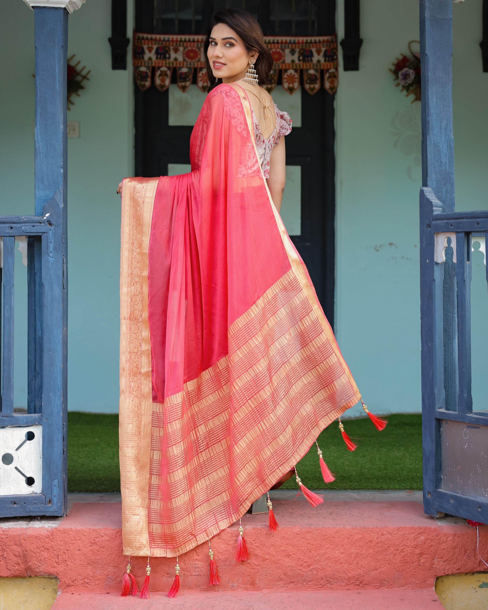 Vibrant Coral Pink Plain Chiffon Saree with Gold Zari Border, Floral Ruffled Blouse & Tassel Detailing - SEEANS