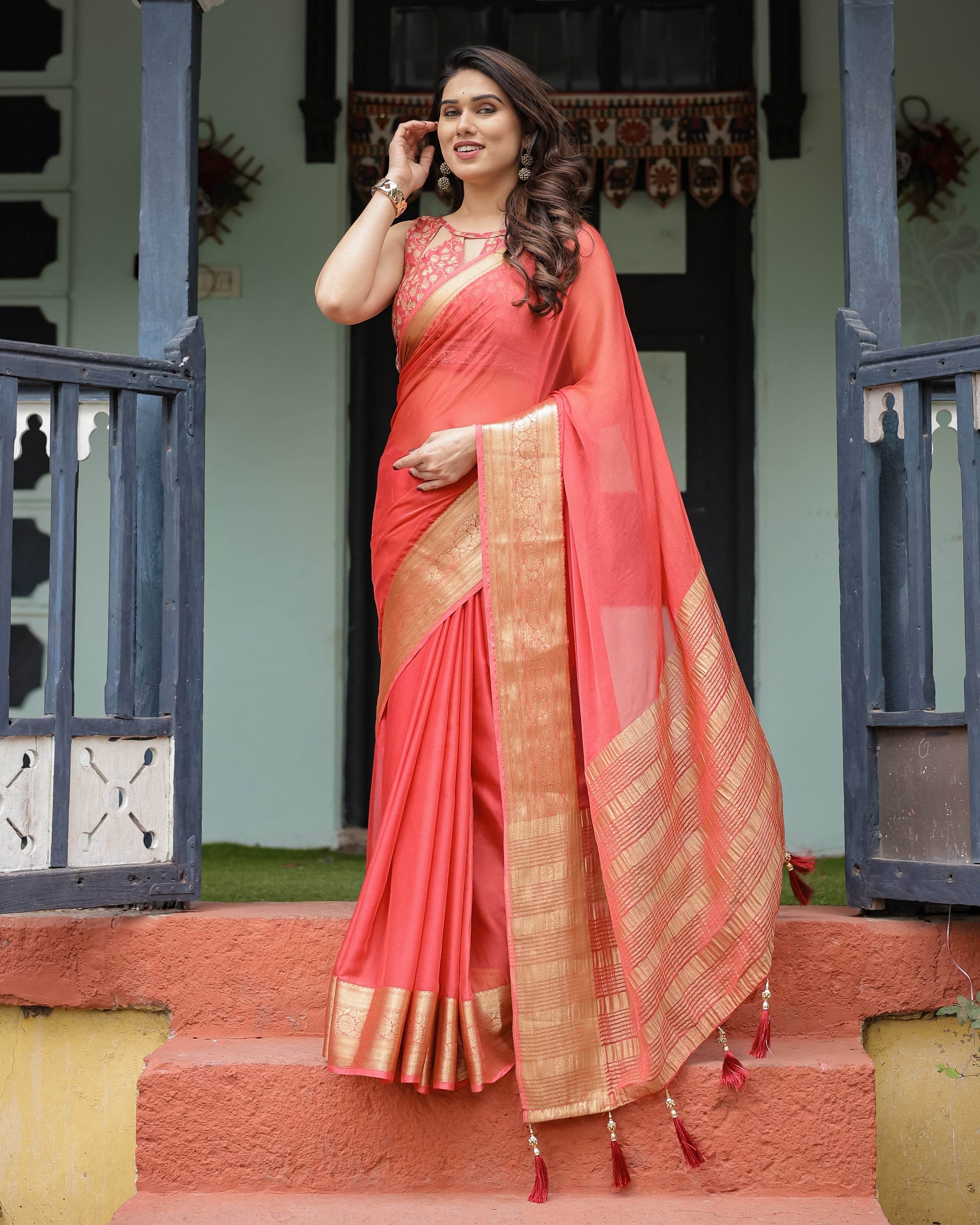 Graceful Coral Pink Plain Chiffon Saree with Gold Zari Border, Floral Embroidered Blouse & Tassel Detailing - SEEANS