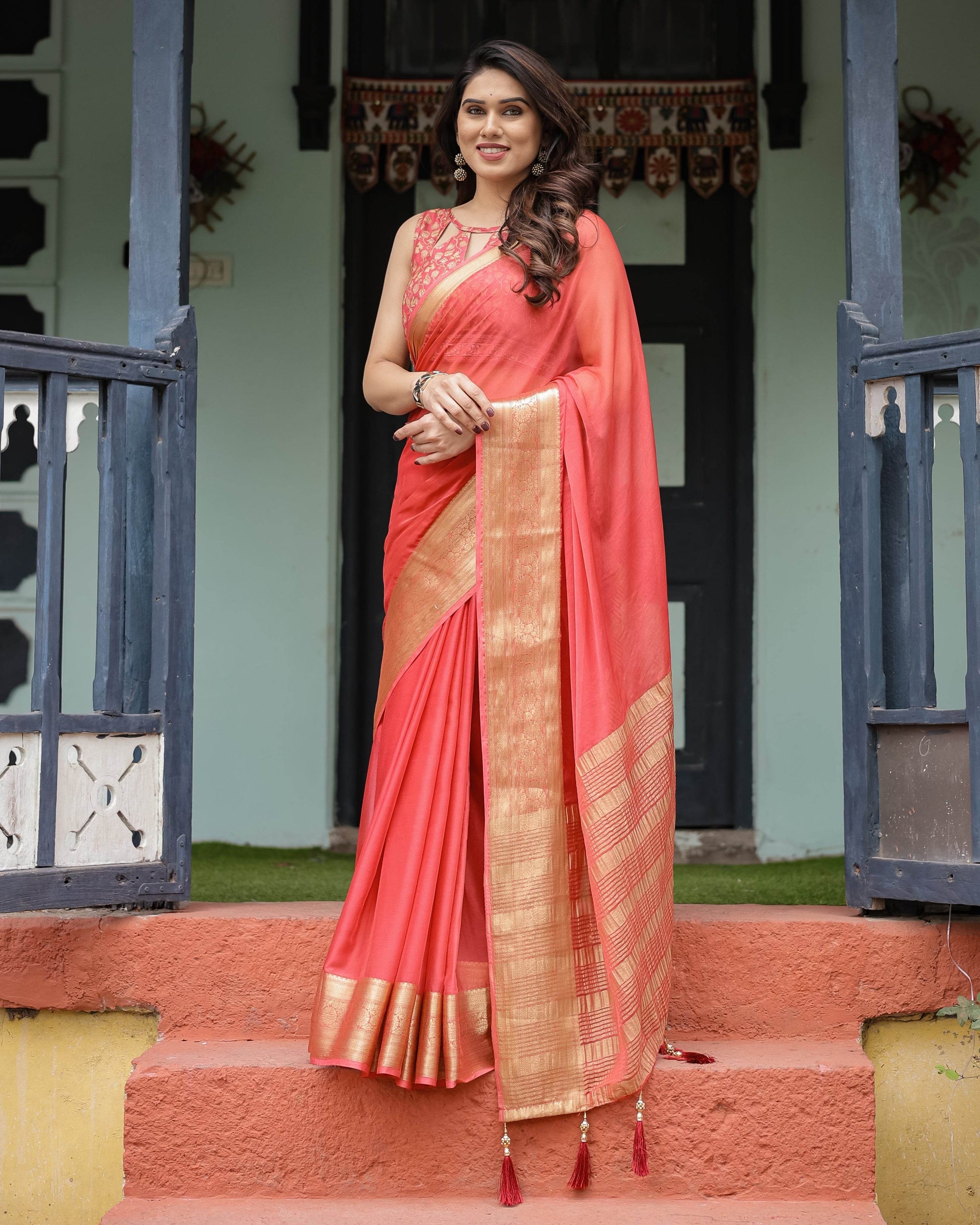 Graceful Coral Pink Plain Chiffon Saree with Gold Zari Border, Floral Embroidered Blouse & Tassel Detailing - SEEANS