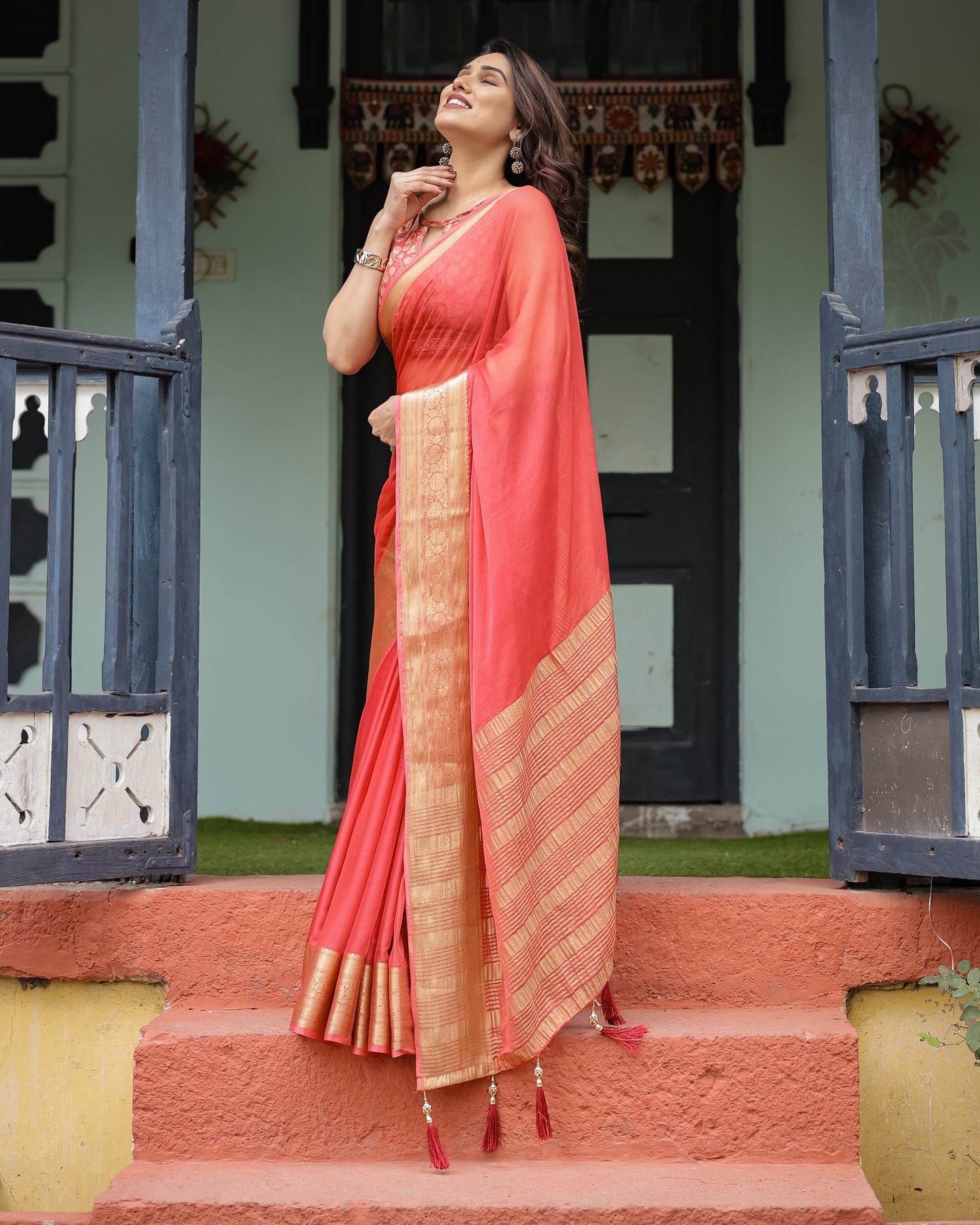 Graceful Coral Pink Plain Chiffon Saree with Gold Zari Border, Floral Embroidered Blouse & Tassel Detailing - SEEANS