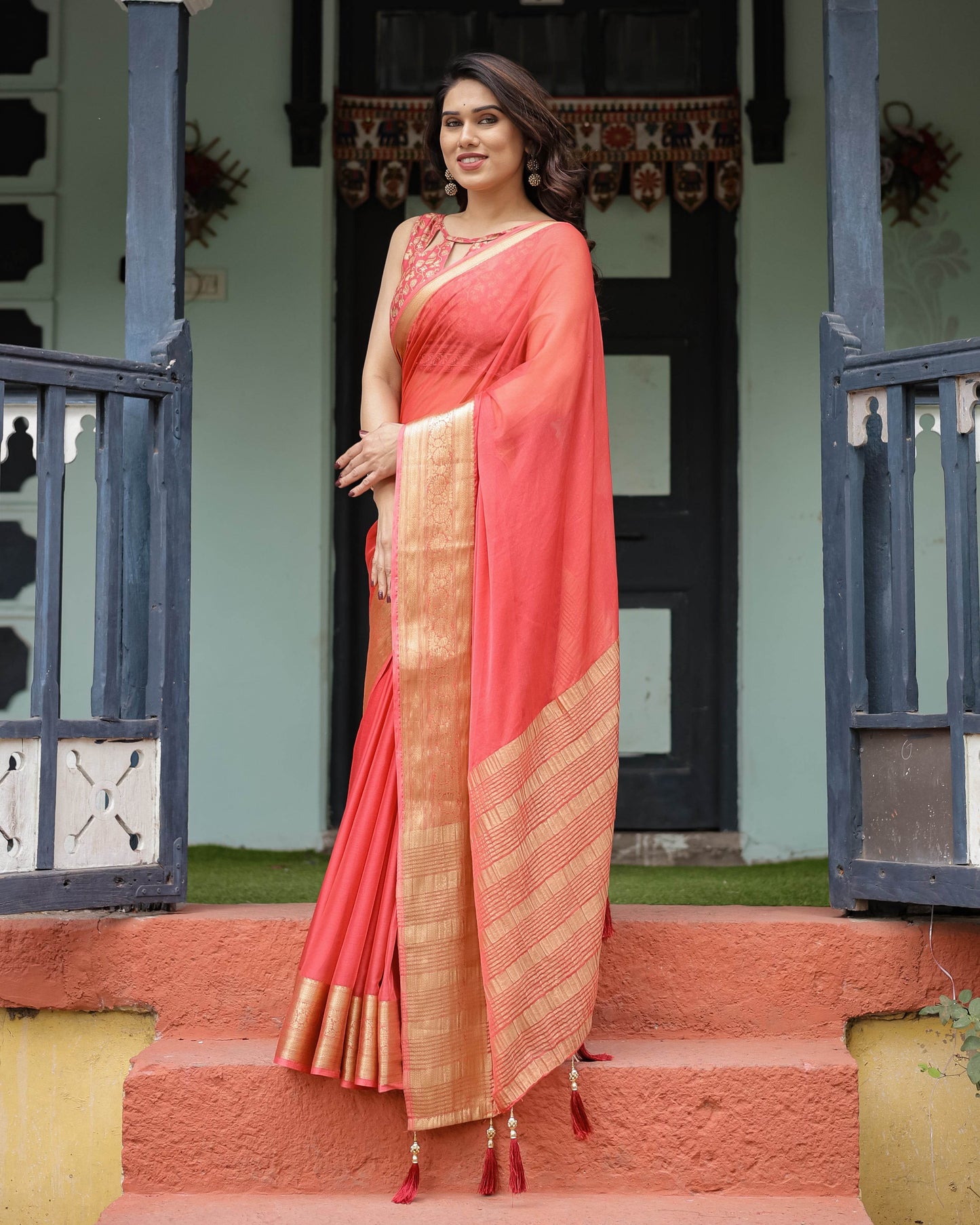 Graceful Coral Pink Plain Chiffon Saree with Gold Zari Border, Floral Embroidered Blouse & Tassel Detailing - SEEANS