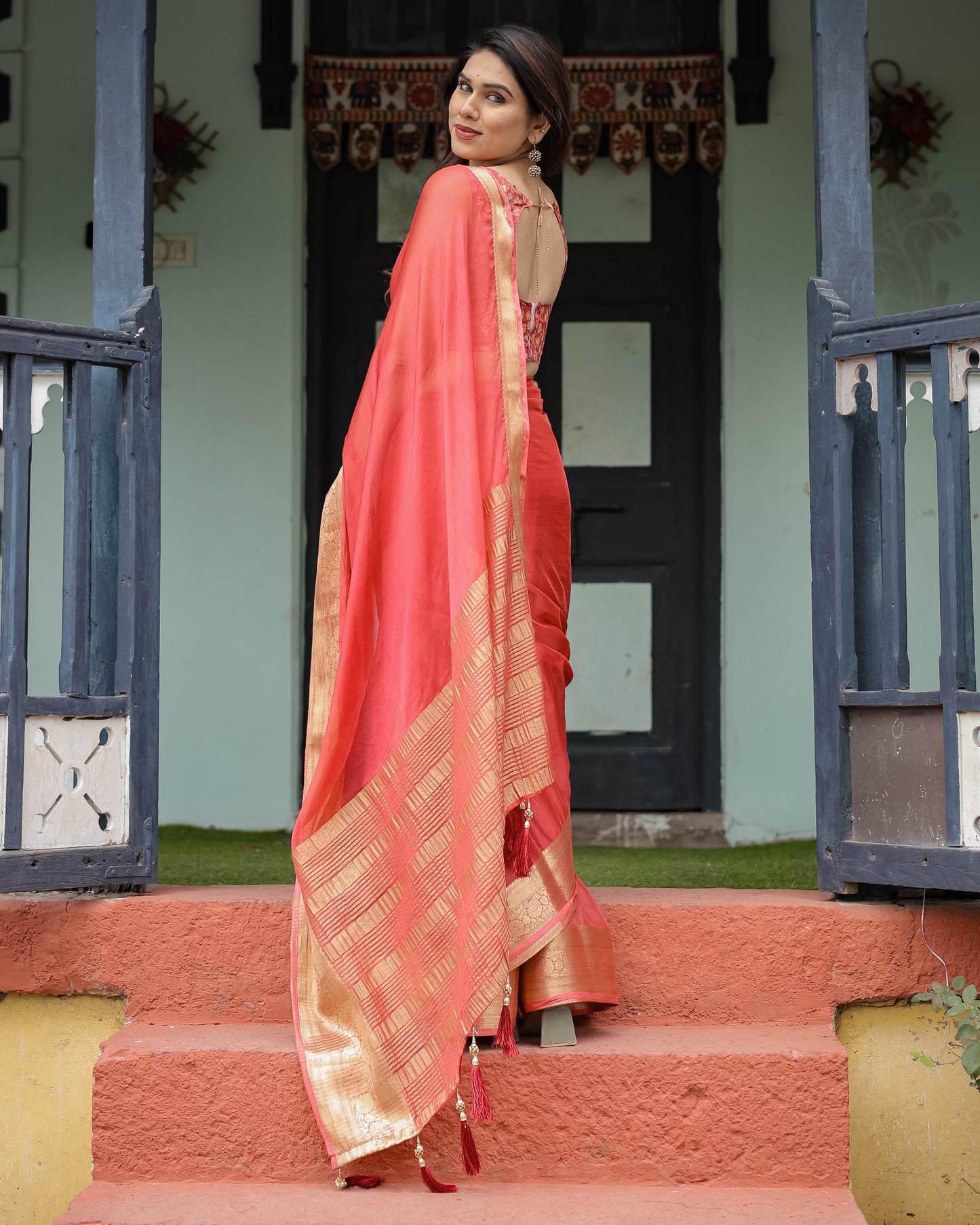 Graceful Coral Pink Plain Chiffon Saree with Gold Zari Border, Floral Embroidered Blouse & Tassel Detailing - SEEANS