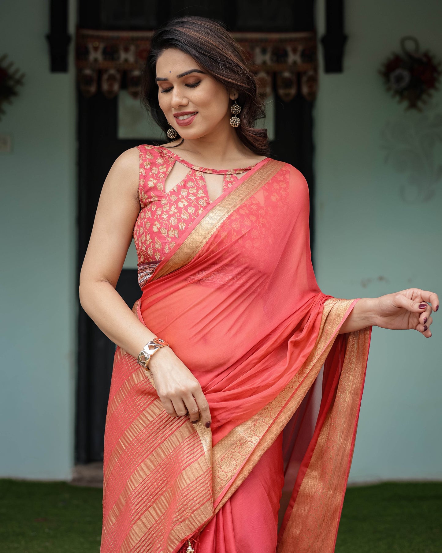 Graceful Coral Pink Plain Chiffon Saree with Gold Zari Border, Floral Embroidered Blouse & Tassel Detailing - SEEANS