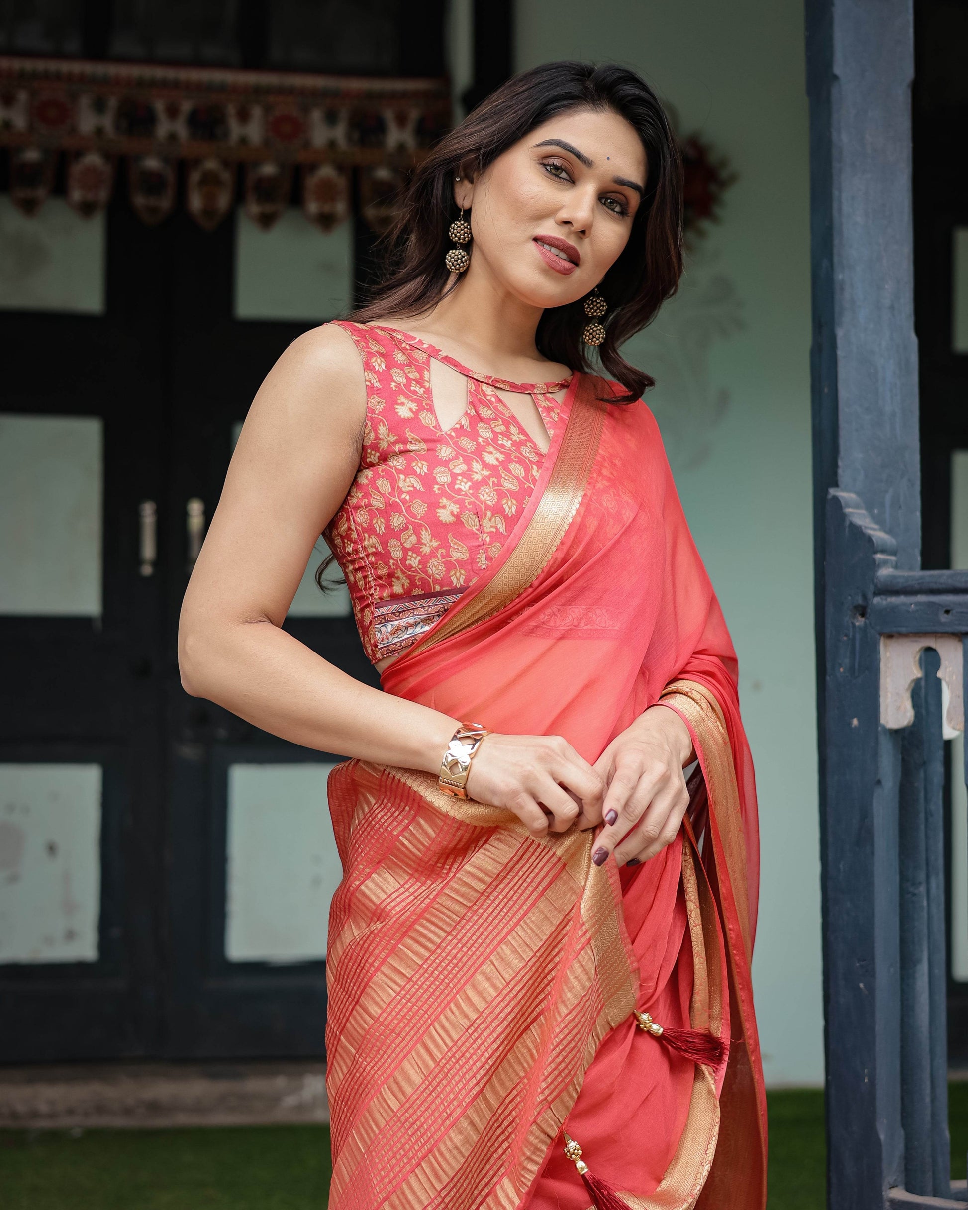 Graceful Coral Pink Plain Chiffon Saree with Gold Zari Border, Floral Embroidered Blouse & Tassel Detailing - SEEANS