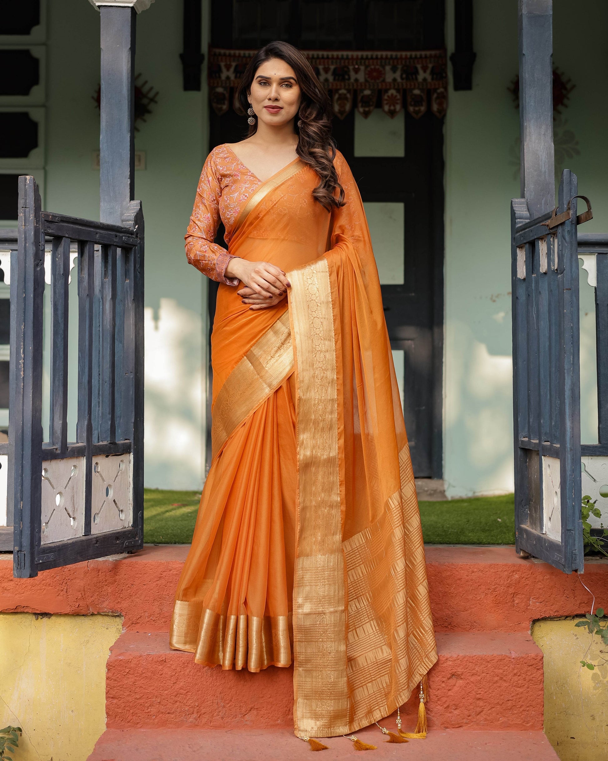 Sunset Orange Plain Chiffon Saree with Gold Zari Border, Floral Embroidered Blouse & Tassel Detailing - SEEANS