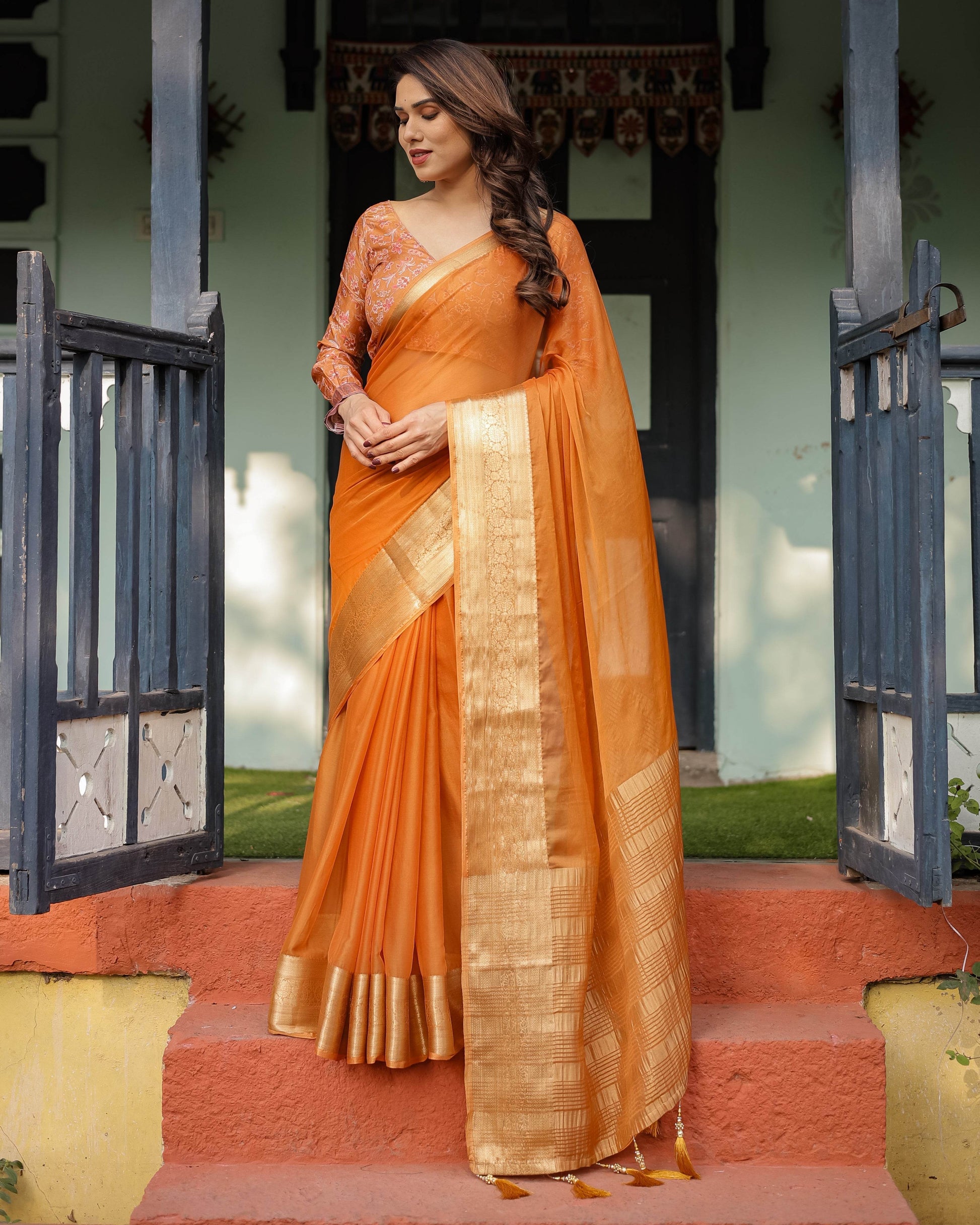 Sunset Orange Plain Chiffon Saree with Gold Zari Border, Floral Embroidered Blouse & Tassel Detailing - SEEANS