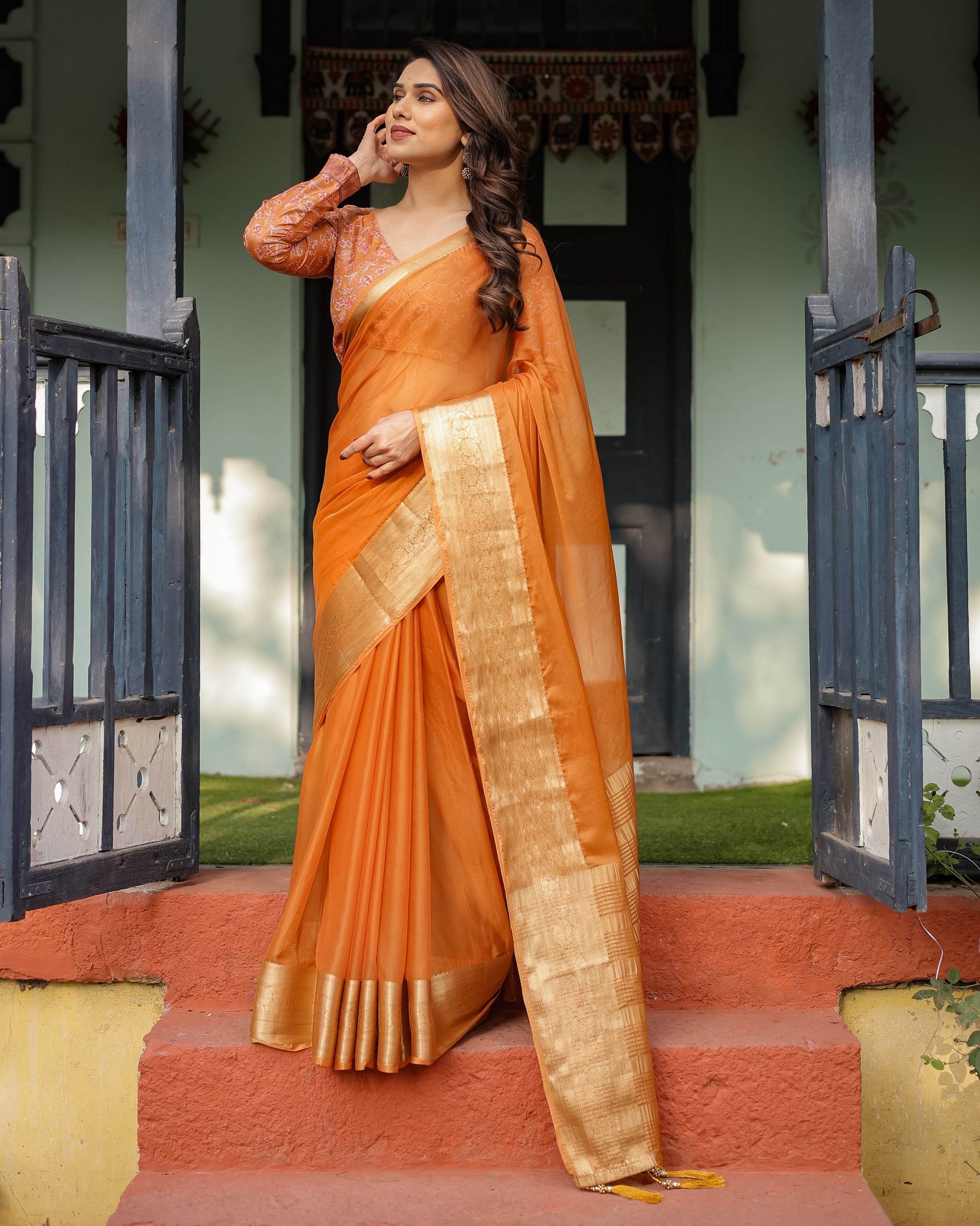 Sunset Orange Plain Chiffon Saree with Gold Zari Border, Floral Embroidered Blouse & Tassel Detailing - SEEANS