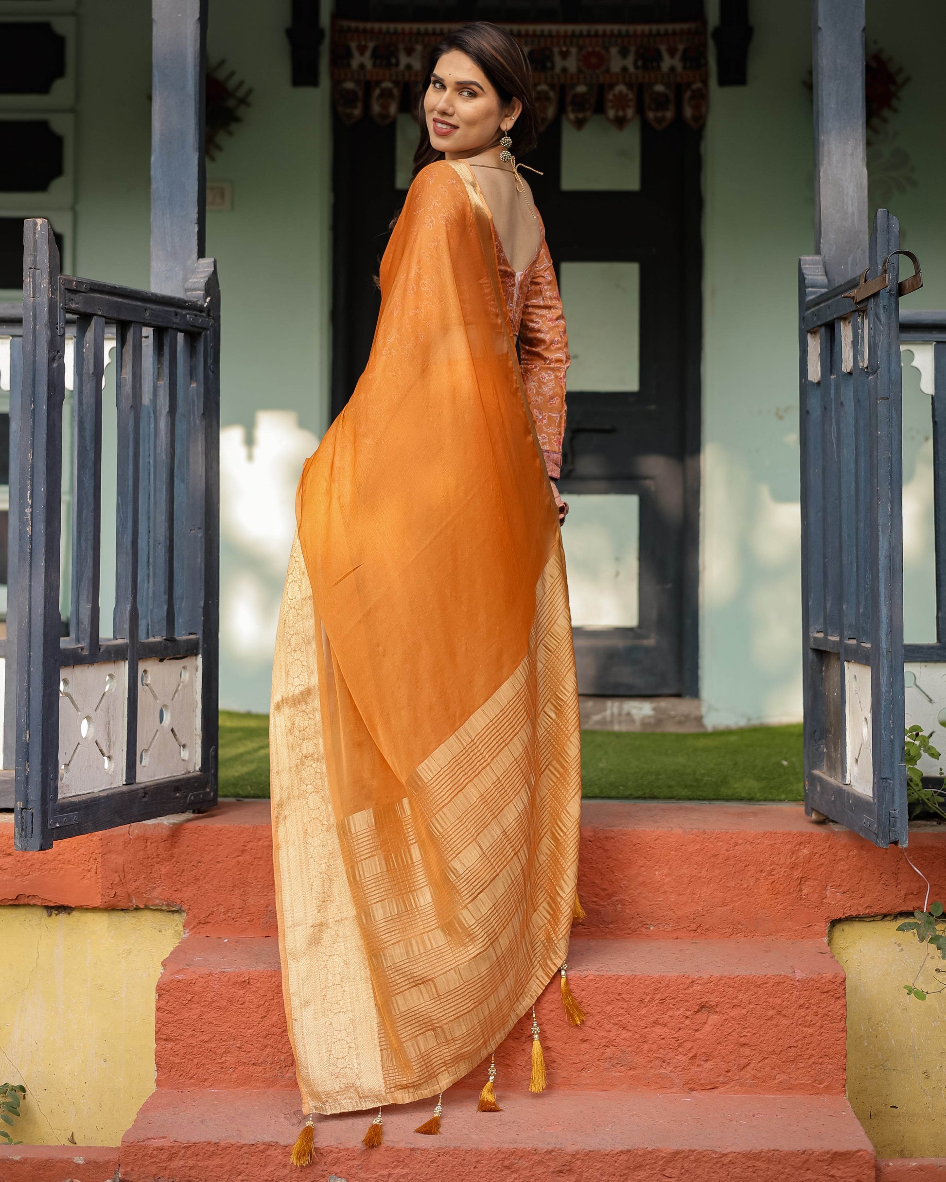 Sunset Orange Plain Chiffon Saree with Gold Zari Border, Floral Embroidered Blouse & Tassel Detailing - SEEANS